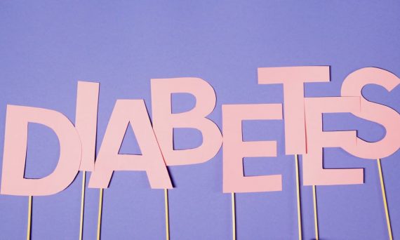 Pink letters spelling 'Diabetes' on a purple background for awareness.